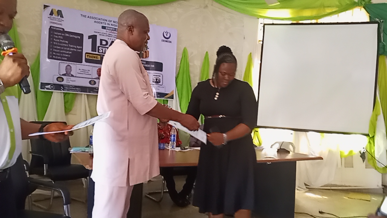 Dr. Ben Odoh presenting certificate to one of the NIN trainees